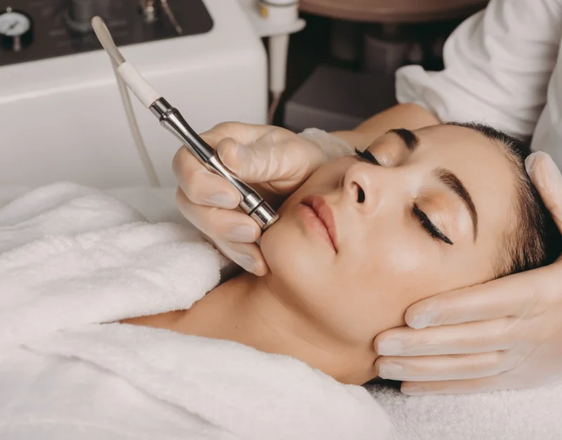 brunette-caucasian-woman-having-spa-procedure-skin-her-face-done-with-apparatus-by-spa-worker